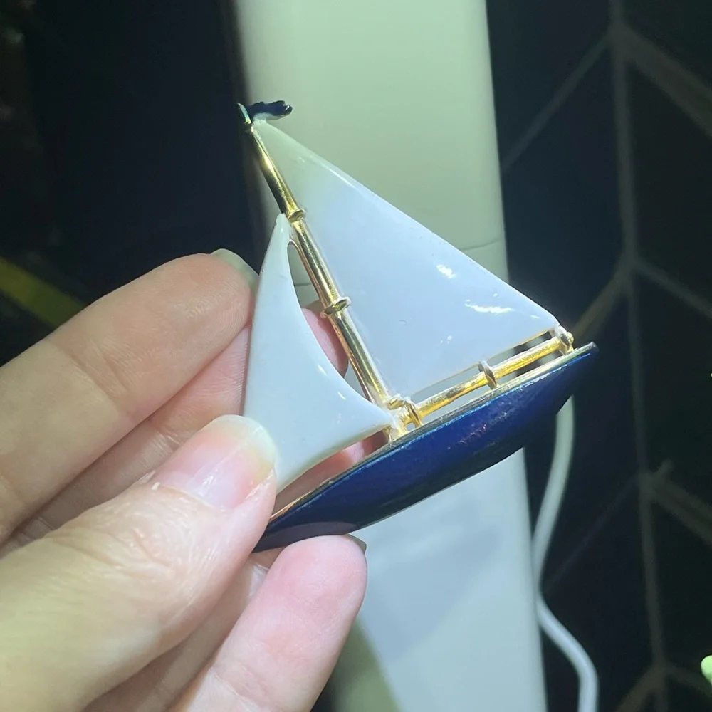 Gold tone sailboat brooch with white and blue enamel